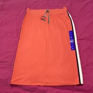 Sports skirt. Tommy Hilfiger. Sz L orange with strips on side, black and white.